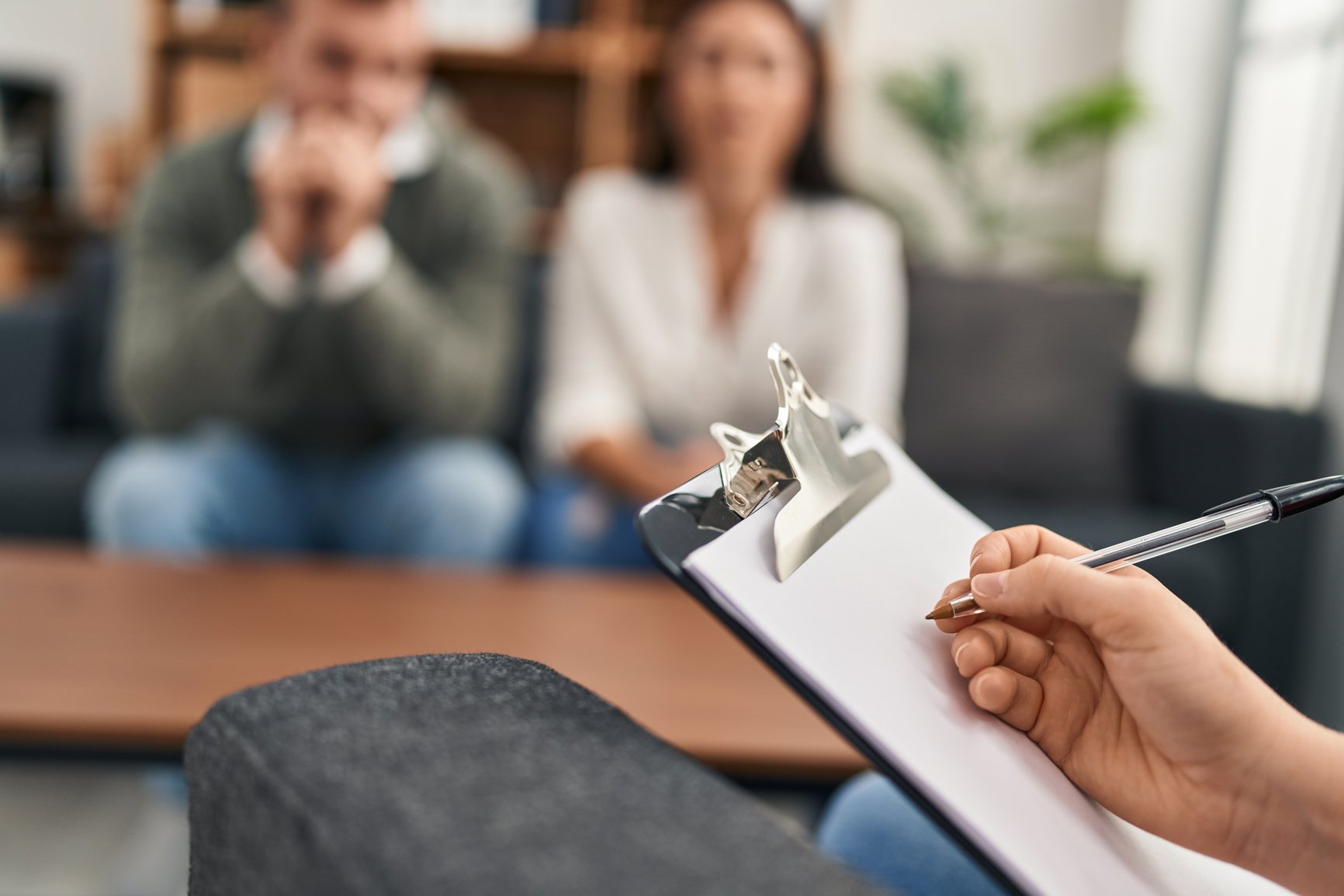 Man and woman having couple therapy session at psychology clinic